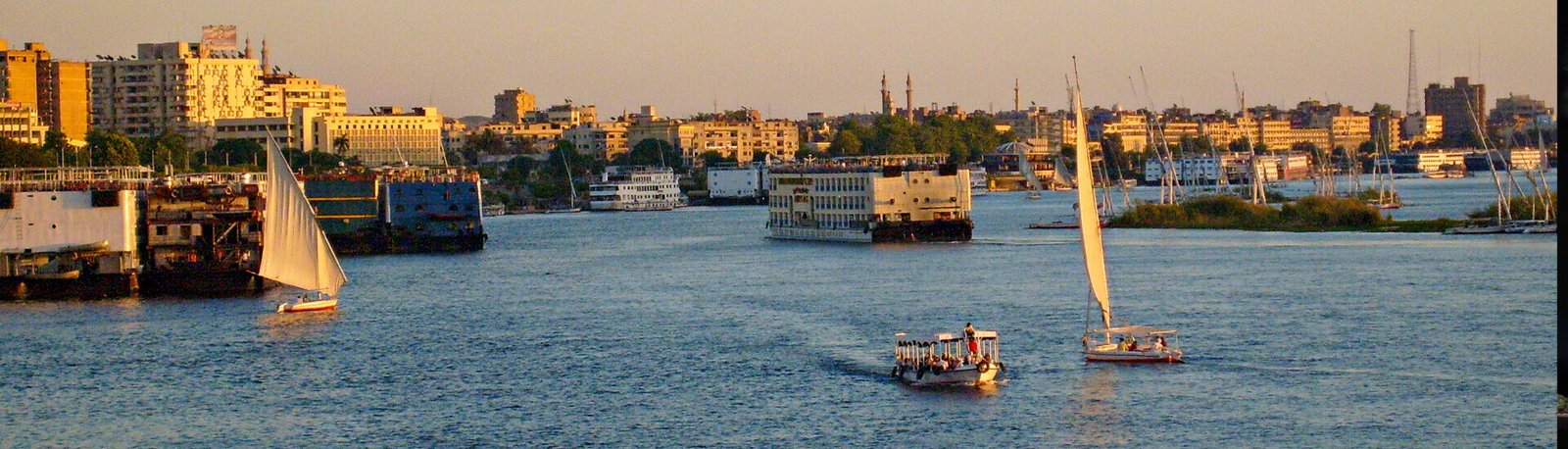 a picture of a felucca and a nile cruise on the nile river in the beautiful city of aswan in egypt