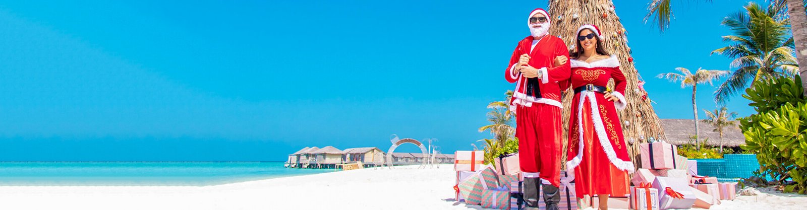 a picture of a male and female tourist celebrating christmas on an egyptian beach