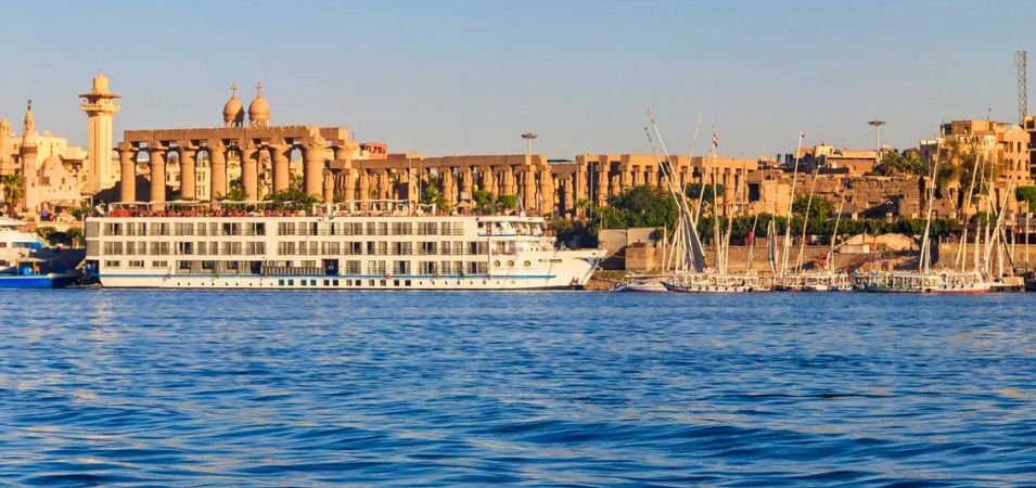 Scenic solo Nile cruise adventure view of the large ship and ancient Egyptian temples at Luxo