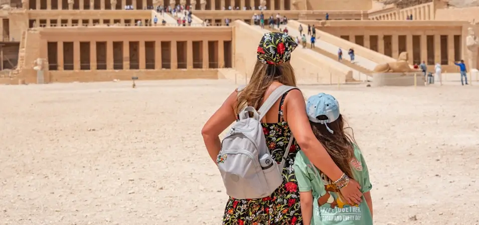 A stunning photo of a tourist and her daughter standing in front of the Temple of Hatshepsut