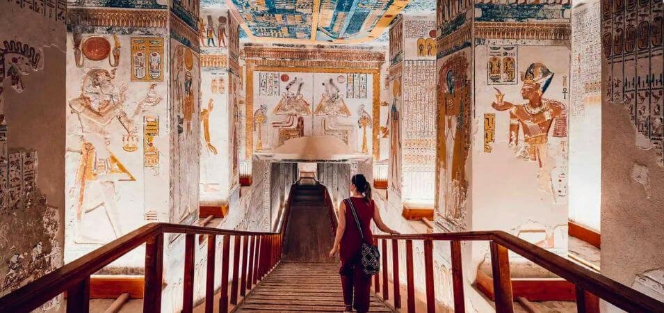 Tourist descending into the brightly painted Tomb of a Pharaoh in the Valley of the Kings