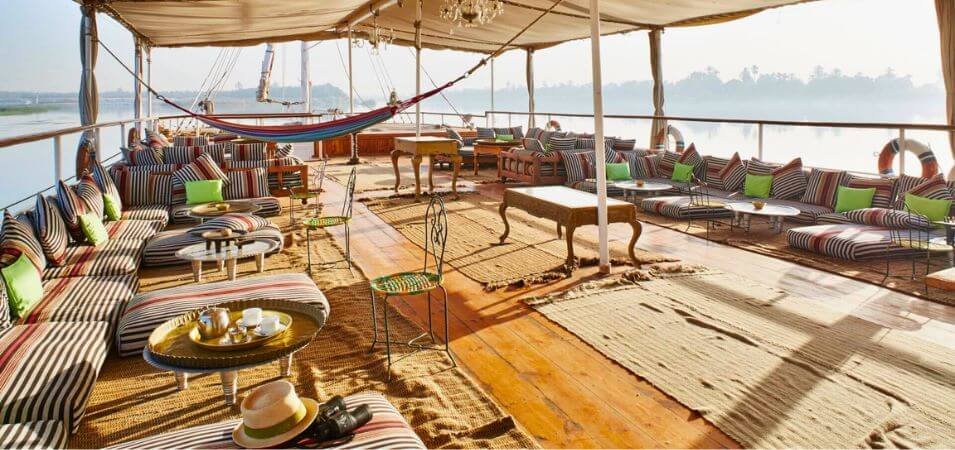 Comfortable deck for relaxation on a traditional dahabiya, embodying luxurious Nile cruises experiences.