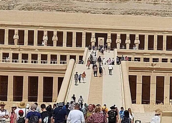 Tourists visiting the multi-tiered Ancient Temple near the Valley of the Kings and Tomb of Ramses
