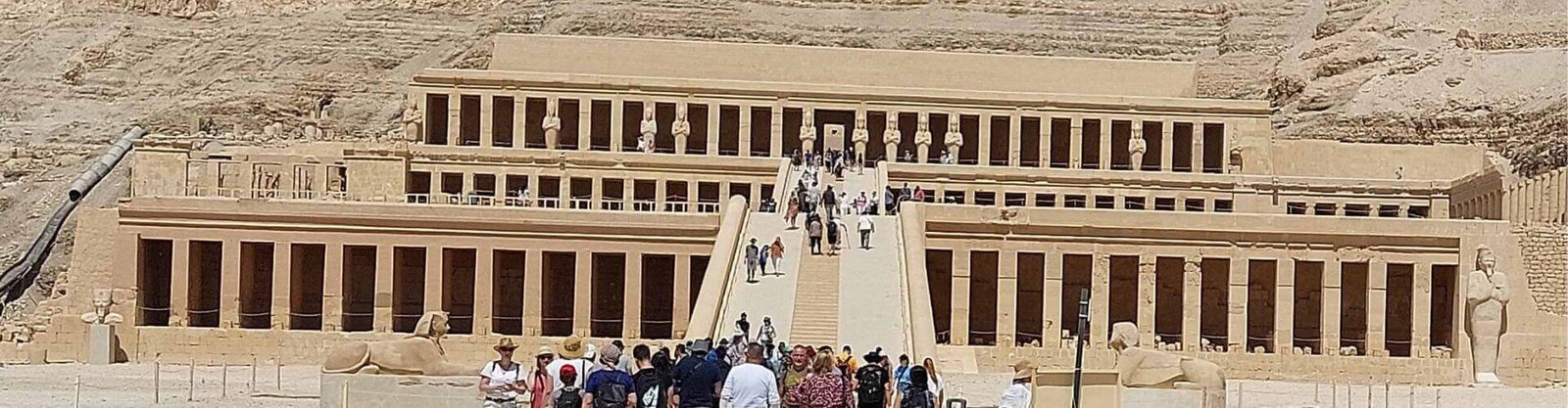Tourists visiting the multi-tiered Ancient Temple near the Valley of the Kings and Tomb of Ramses