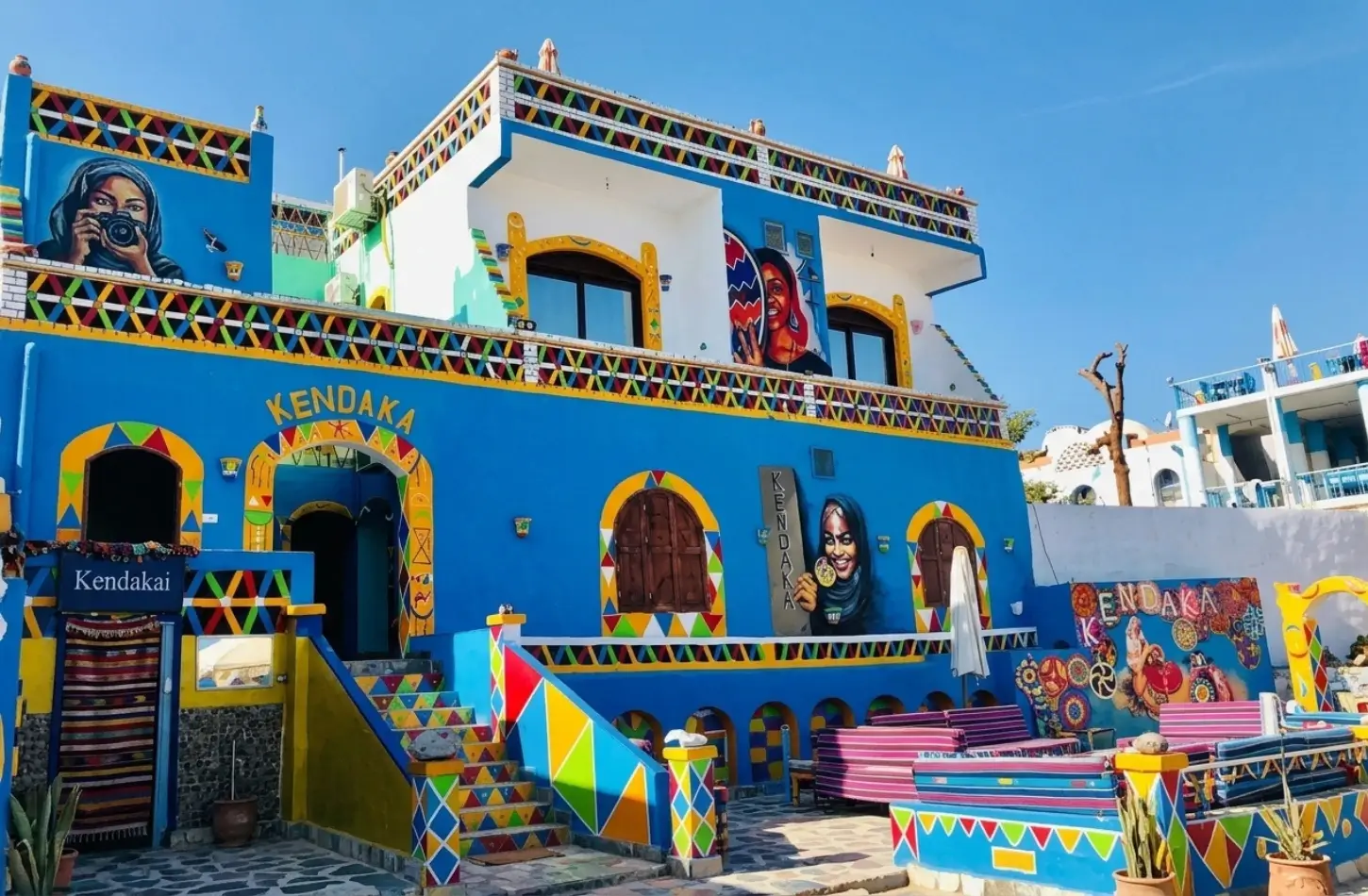 Nubian Village Aswan: A Complete Guide to Gharb Soheil's Colorful Culture 2 Vibrantly painted Kendaka guesthouse featuring artistic murals in the Nubian Village in Aswan, Egypt.