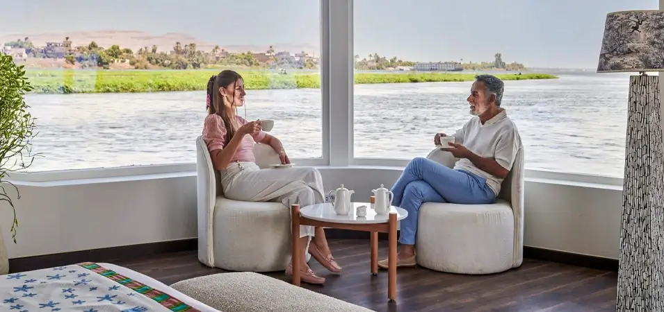 Best Time for a Nile Cruise in Egypt (Month-by-Month 2026) — Weather, Prices & Tips 2 A stunning photo of a couple sitting inside a cruise ship
