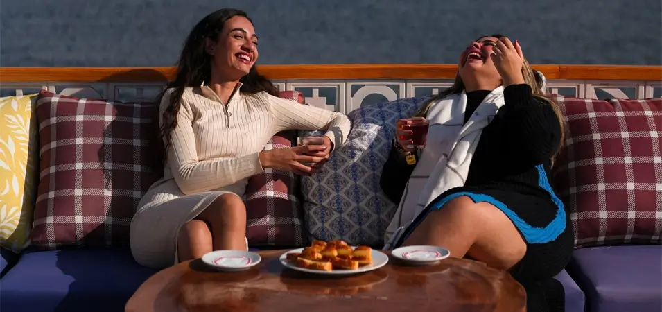 Best Time for a Nile Cruise in Egypt (Month-by-Month 2026) — Weather, Prices & Tips 3 A wonderful picture of two girls sitting on the deck of a cruise ship