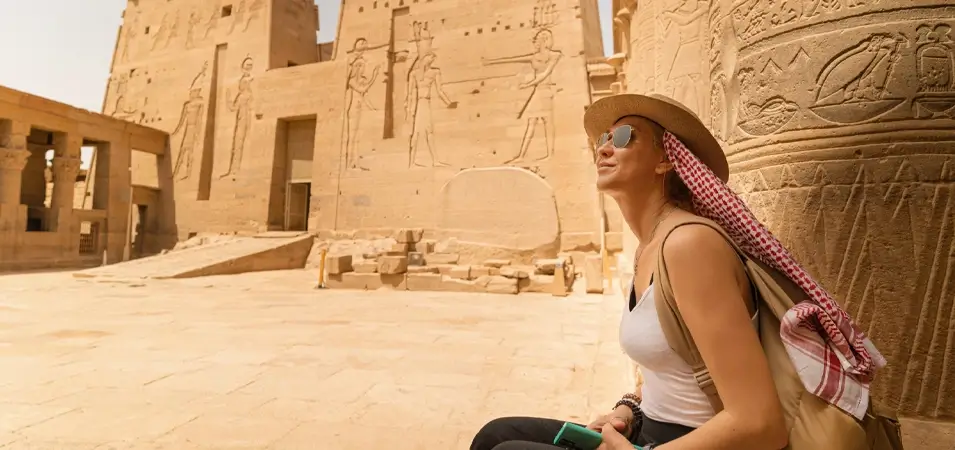 Philae Temple: Complete History & Visiting Guide 2 A stunning image of a girl sitting inside the Philae temple