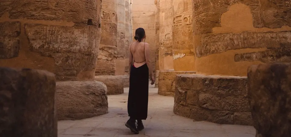 Karnak Temple: A Complete Guide by Yousef Atta 1 A stunning image of a girl standing inside the hypostyle hall of Karnak Temple