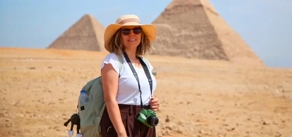 Planning a Trip to Egypt: A Local Expert's Complete Guide 3 A stunning photo of a girl standing in front of the pyramids holding a camera
