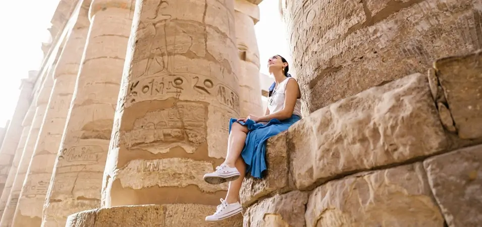 Solo Nile Cruise Adventure: A Complete Guide from an Egypt-Based Travel Expert 2 A stunning photo of a tourist sitting inside the Karnak Temple