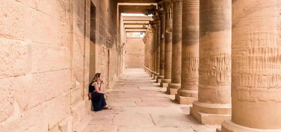 Planning a Trip to Egypt: A Local Expert's Complete Guide 1 A stunning photo of a tourist sitting inside the Philae Temple