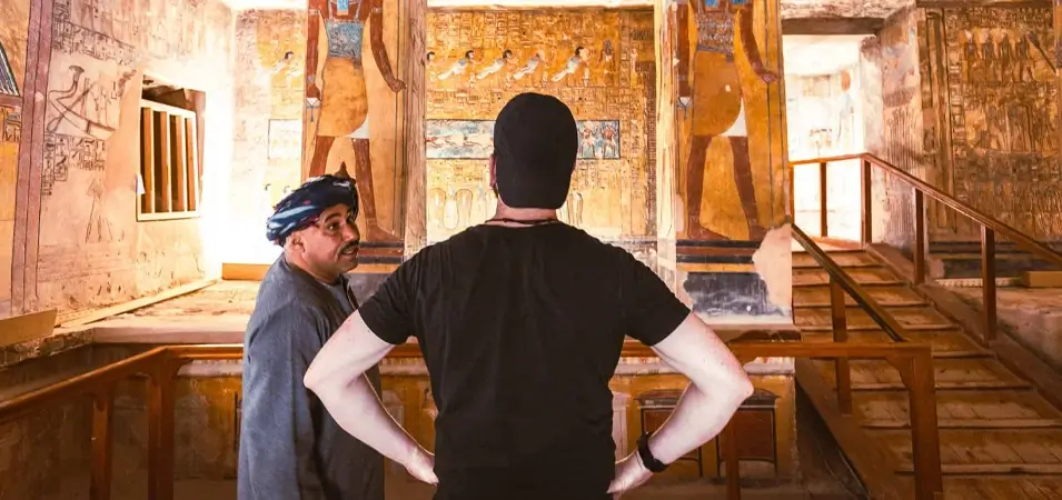 Valley of the Kings, Luxor: Complete History & 2026 Visitor Guide 2 A stunning photograph of a tourist and a ranger standing inside the Valley of the Kings